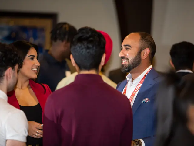 LANG students and faculty connecting at a networking event